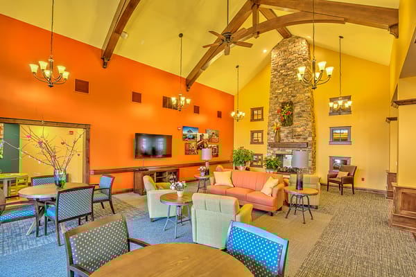 Bright common area with seating and a fireplace