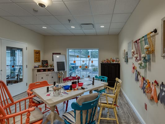 Bright activity room with colorful chairs and craft supplies