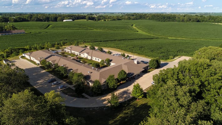 Aerial view of the facility surrounded by green fields