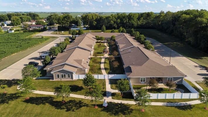 Aerial view of a senior living facility with landscaped grounds