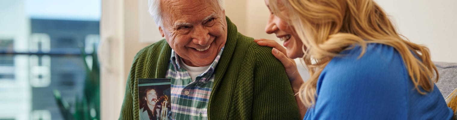 Senior resident sharing memories with a visitor