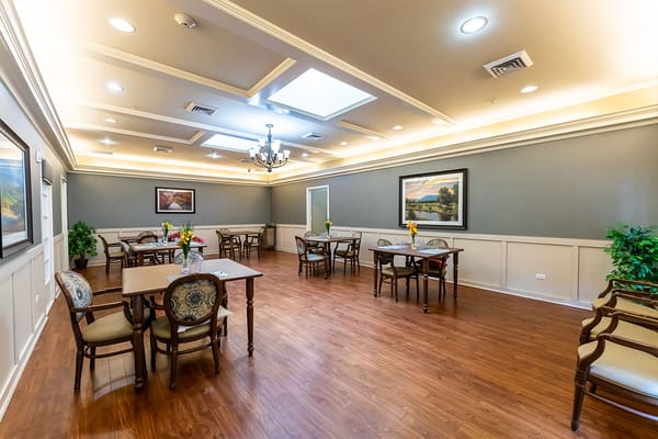 Well-lit common area with tables and chairs