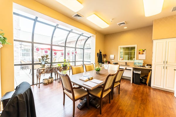 Bright common area with dining table and plants