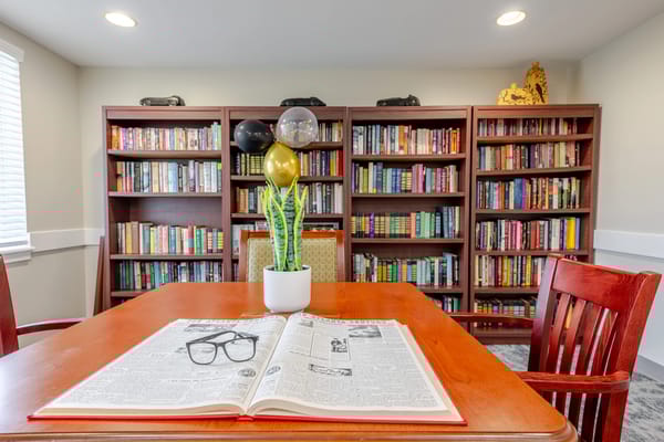 Common area with bookshelves and a reading table