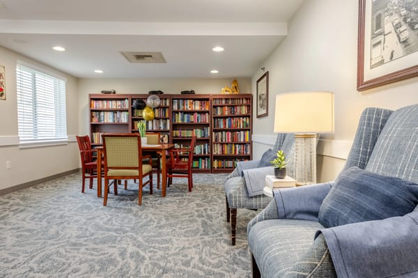 A cozy common area with bookshelves and seating