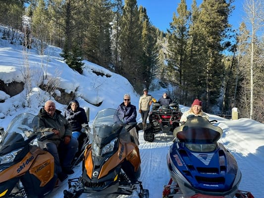 Residents enjoying snowmobiling in a snowy setting