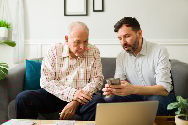 A senior man and caregiver engaging in conversation.