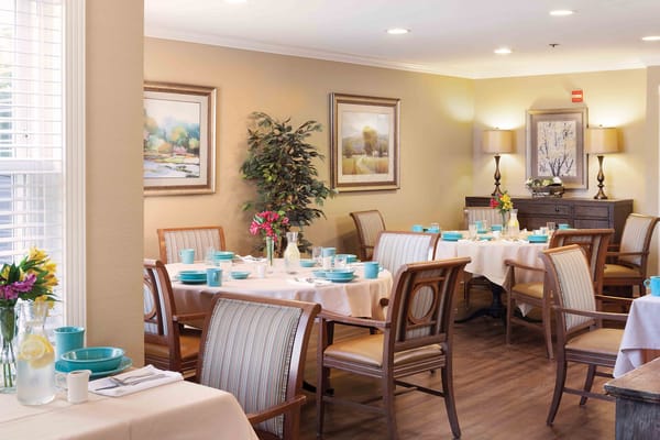 Bright dining room with tables set for meals