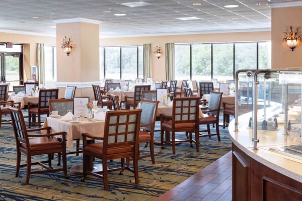Dining area with tables and chairs in a well-lit room