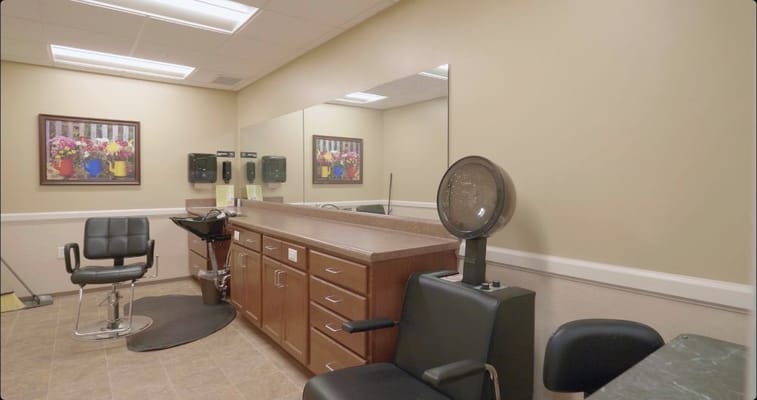 Interior of a salon area with styling chairs and mirrors