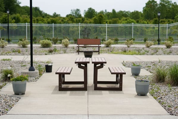 Outdoor seating area with picnic tables and planters