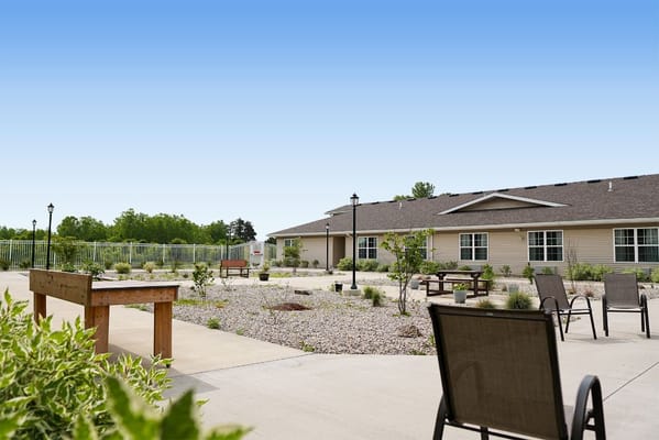 Outdoor seating area with a garden in the background