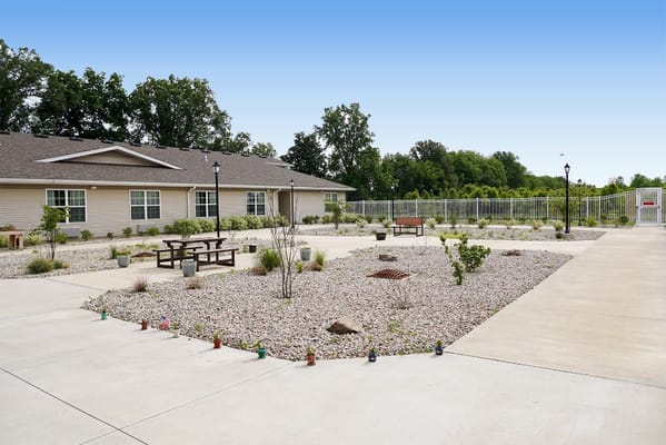 Outdoor space with seating and landscaping in front of the facility