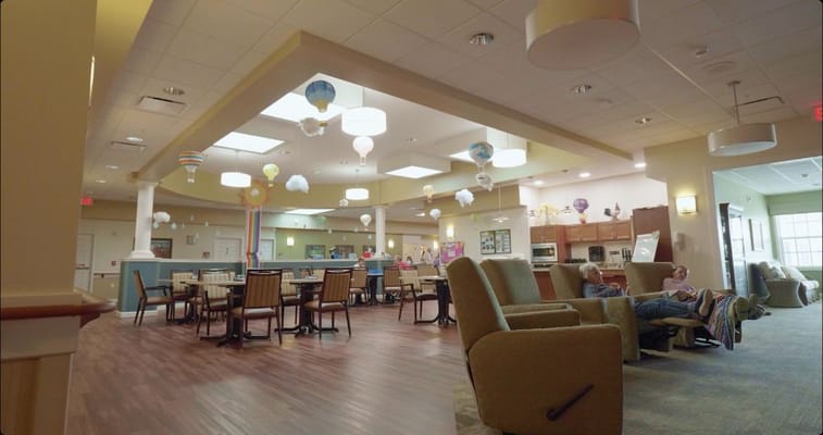 Bright common area with residents relaxing and colorful decor