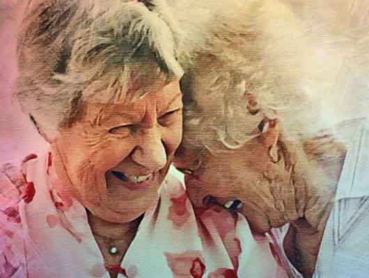 Two smiling women sharing a moment together