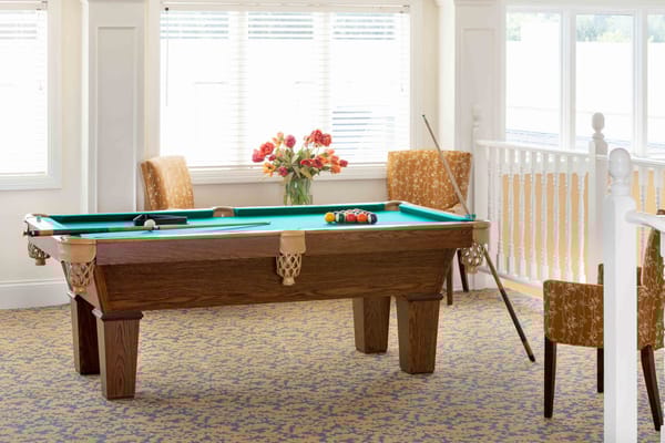 Billiards table in a brightly lit activity room