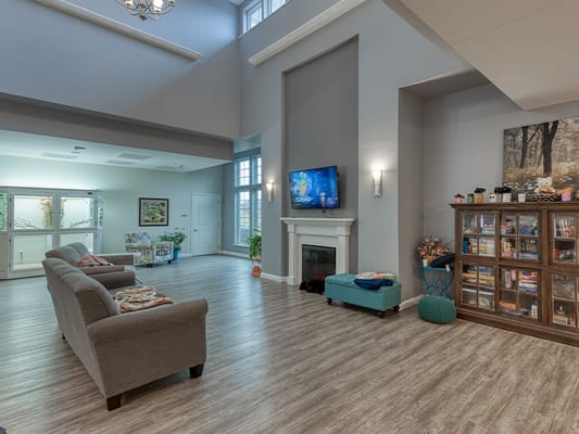 Bright common area with seating and TV.