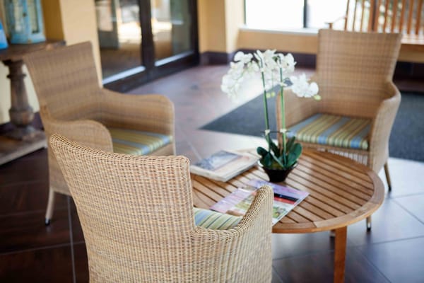 Interior seating area with wicker chairs and a table