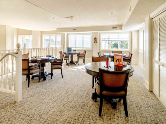 Bright activity room with tables and chairs for games