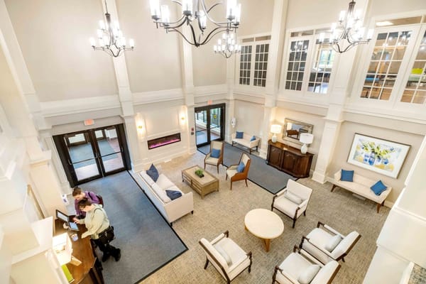 Bright lobby area with staff assisting residents