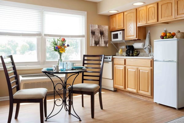 Cozy kitchen area with a dining table and flowers