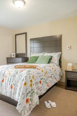 Cozy bedroom setup with floral bedding and natural light