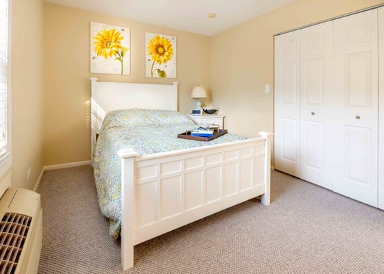 Cozy bedroom with sunflower wall art and a bed