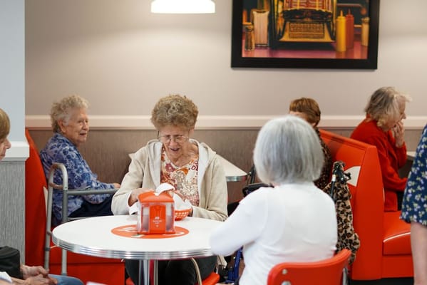 Residents enjoying a meal in a dining area