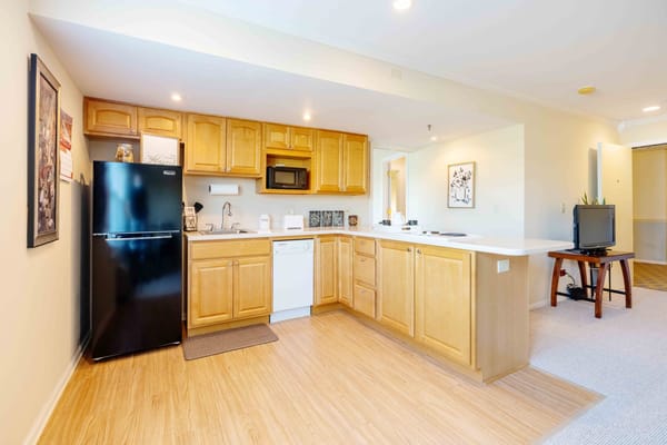 A well-furnished kitchen area in a resident unit