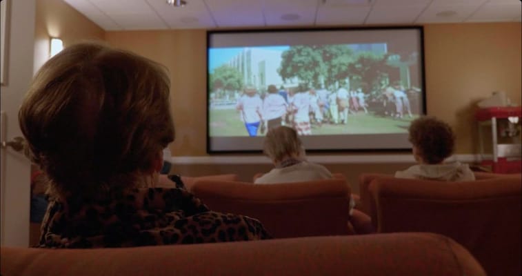 Residents watching a movie in a common area