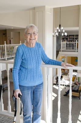 Resident smiling in a well-lit interior common area