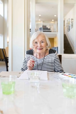 Resident engaging in painting activity indoors