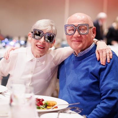 Residents enjoying a festive meal with oversized glasses