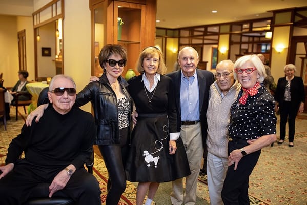 Residents and staff posing for a photo in the common area