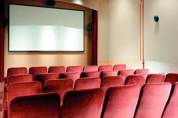 Interior view of a red theater room with seating