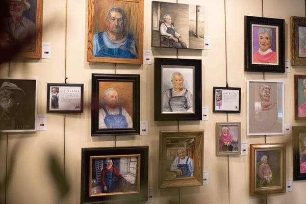 Gallery wall with portraits of residents