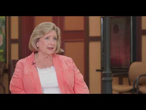 A resident talking in a warm interior setting