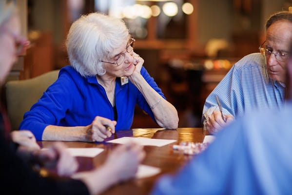 Residents engaged in an activity around a table