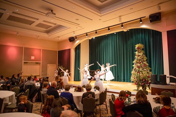 Residents and children enjoying a performance in the common area