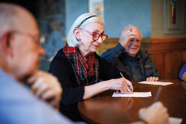 Residents engaged in a group activity at a table