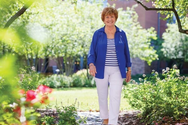 A resident walking through a garden area