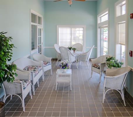 Bright common area with wicker furniture and plants