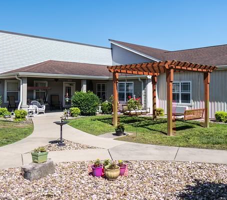 Exterior view of the facility with gardens and seating