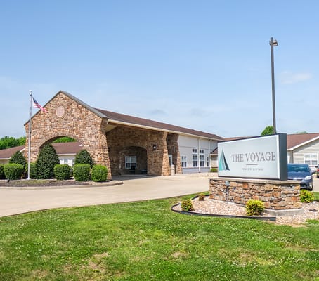 Facility exterior view with signage and landscaping.