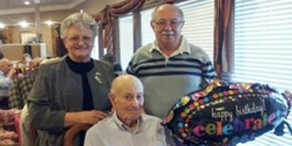 Residents celebrating a birthday with a balloon