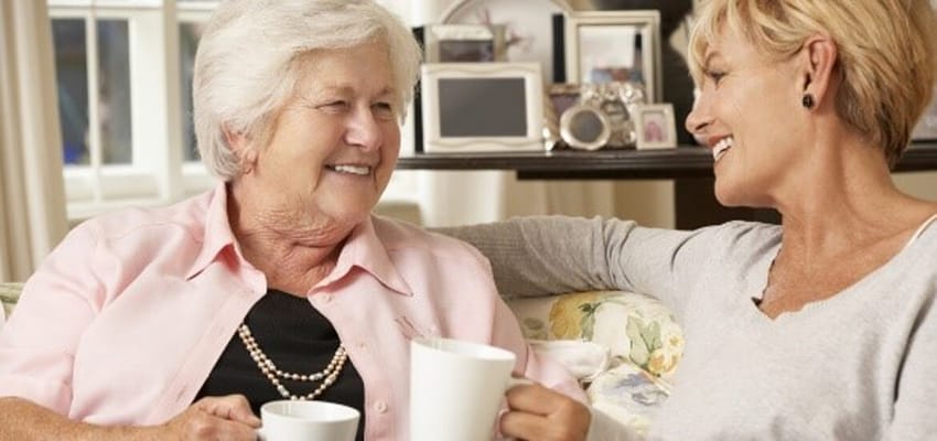 Two women enjoying tea in a cozy living space