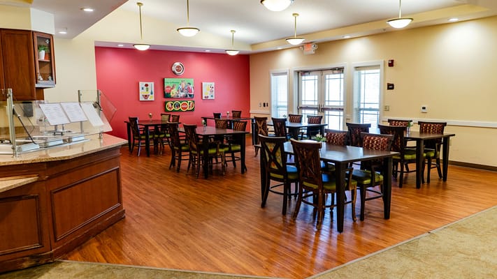 Interior dining area with wooden tables and colorful decor