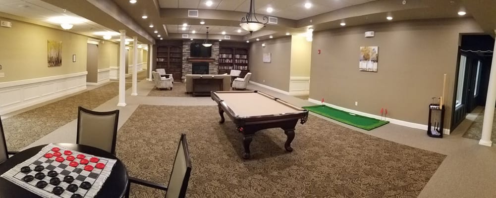 Common area with a pool table and library