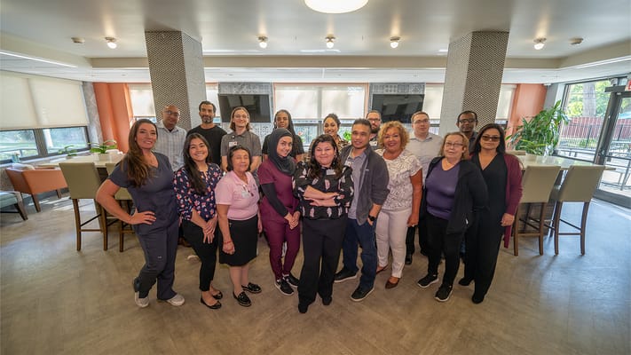 Staff posing in a common area of the facility