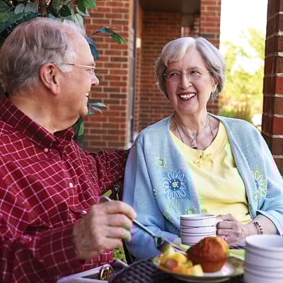 Residents enjoying a meal together on a patio
